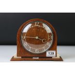 Art Deco style Smiths oak and Bakelite mantle clock of arched form, with cream Arabic numerals,