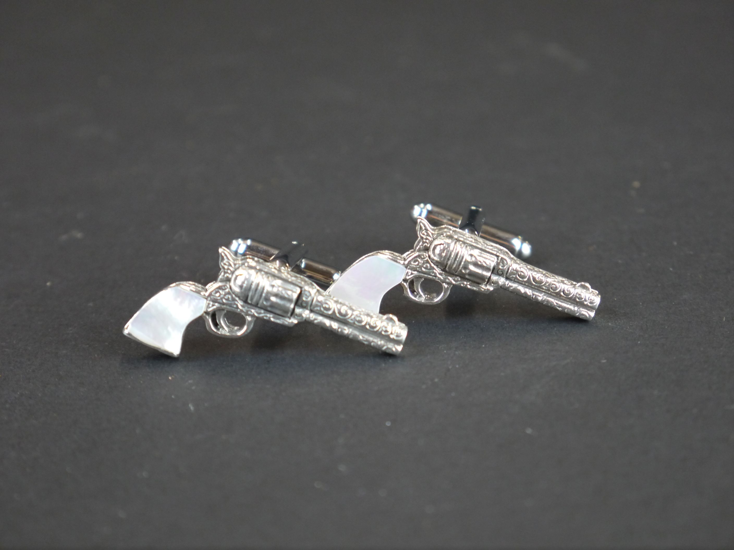 Pair of silver pistol cufflinks with mother-of-pearl handles