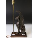 19th century cast iron model of a winged lion, left ear missing, height approx. 32cm, mounted as a