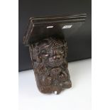 Antique carved oak wall bracket in the form of a lion mask, with square shelf, approx 28cm high