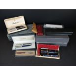 A collection of vintage and contemporary pens and fountain pens to include Parker and Mont Blanc