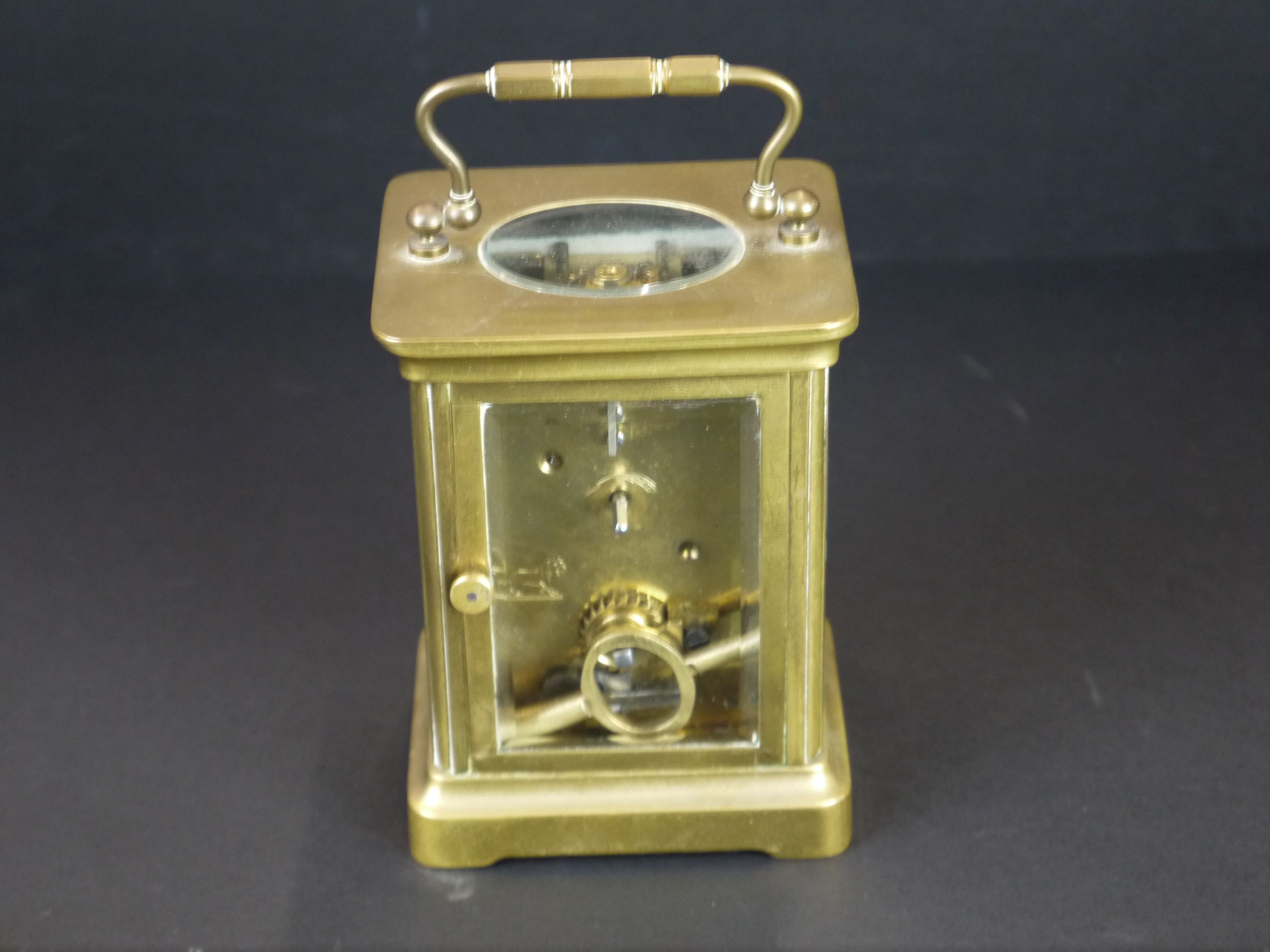An early 20th century brass cased carriage clock with bevelled glass panels and white enamel dial. - Image 3 of 4