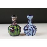 Two Moorcroft pottery vases of bulbous form to include a Violets pattern example on blue ground,