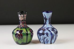 Two Moorcroft pottery vases of bulbous form to include a Violets pattern example on blue ground,