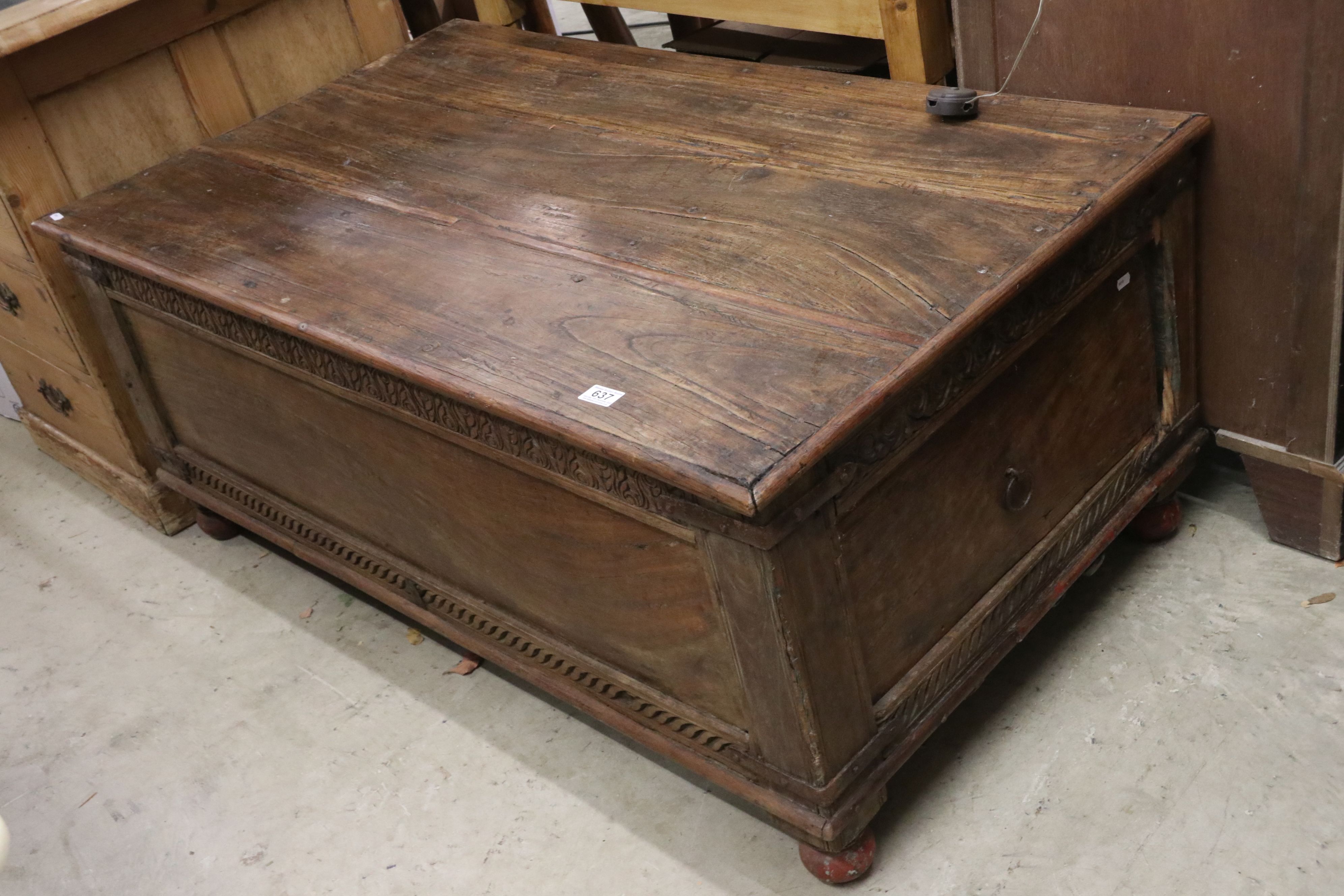 Indian Hardwood and Iron Bound Box Coffee Table, the panelled sides with carved frieze (one end with