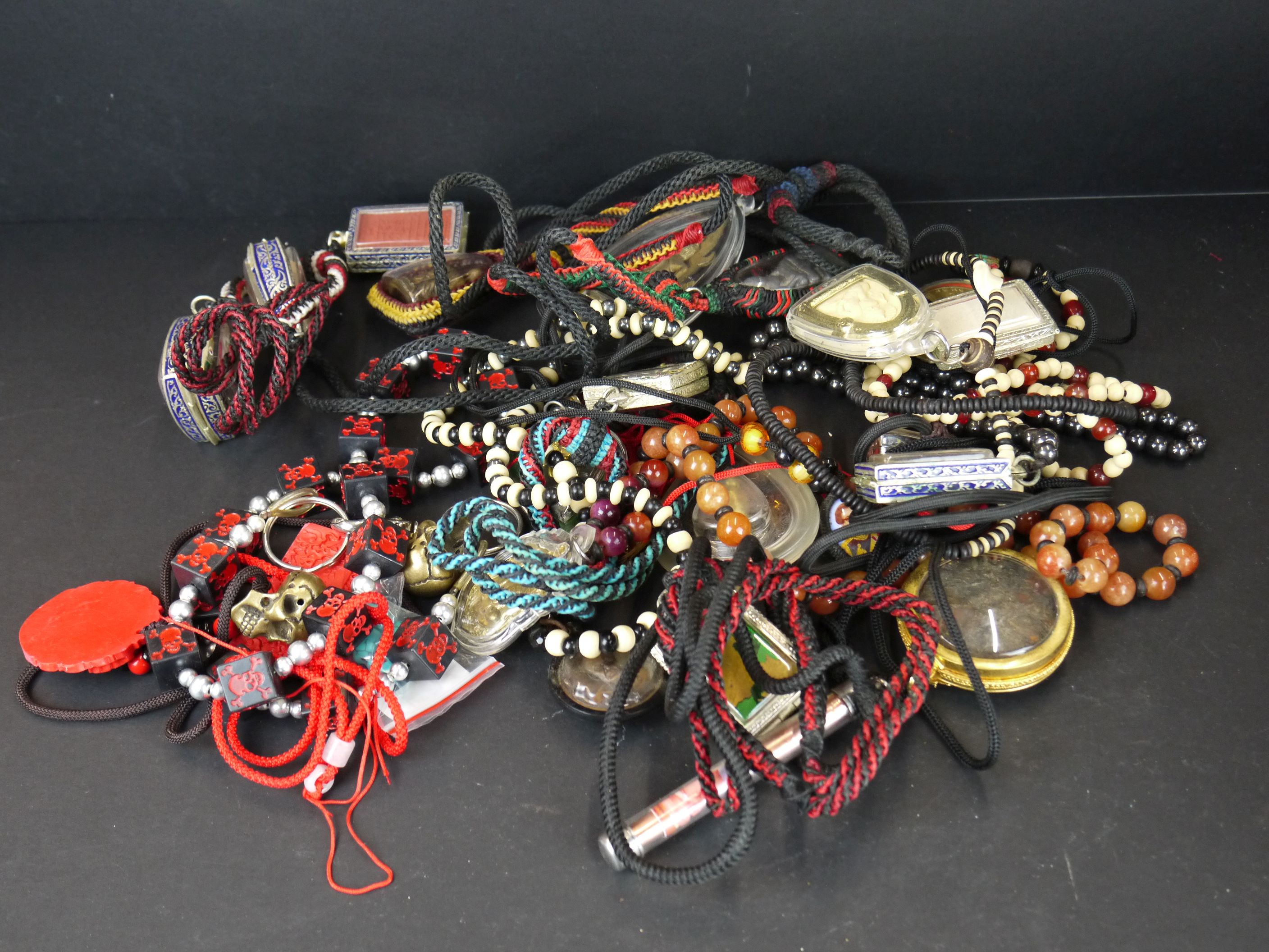 A large collection of oriental strung amulets .