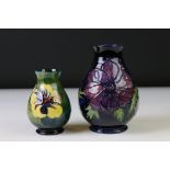 William Moorcroft Hibiscus pattern vase of bulbous form, on green ground, paper label to