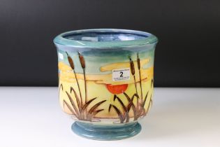 Moorcroft bullrush and landscape pattern planter, raised on a circular foot, signed WM and impressed