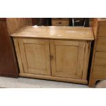 Victorian Pine Dresser Base / Cupboard, the two cupboard doors opening to three shelves, raised on a