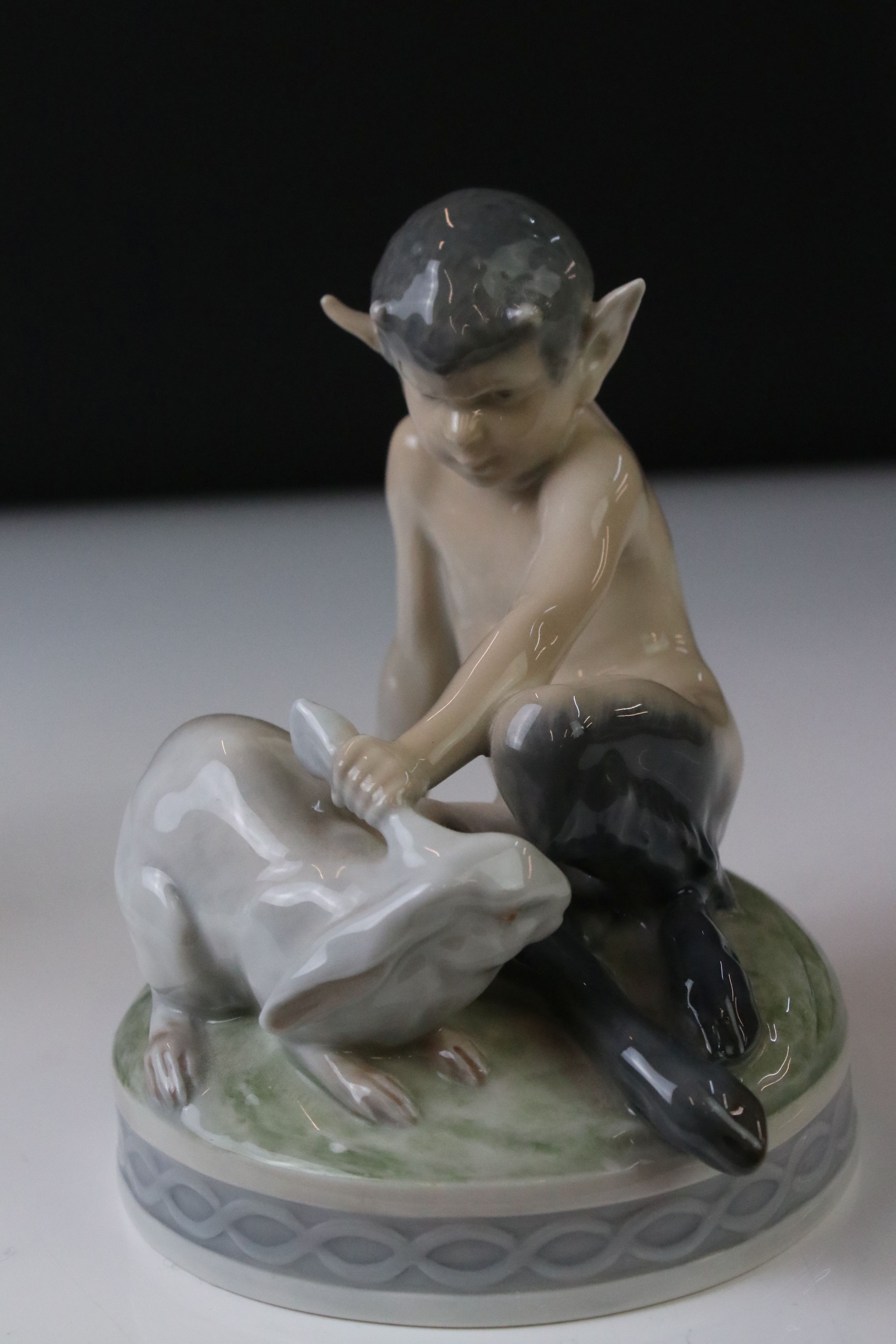 Two Royal Copenhagen porcelain figures to include a faun playing a mouth organ seated on fluted - Image 6 of 9