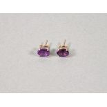A pair of amethyst ear studs, the oval cut stones claw set in silver, 1.4gms