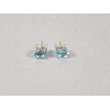 A pair of Swiss blue topaz ear studs, the oval cut stones claw set in silver, 1.5gms