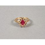 A ruby and diamond dress ring, the oval cut ruby within a band of diamonds, set in a 9ct gold