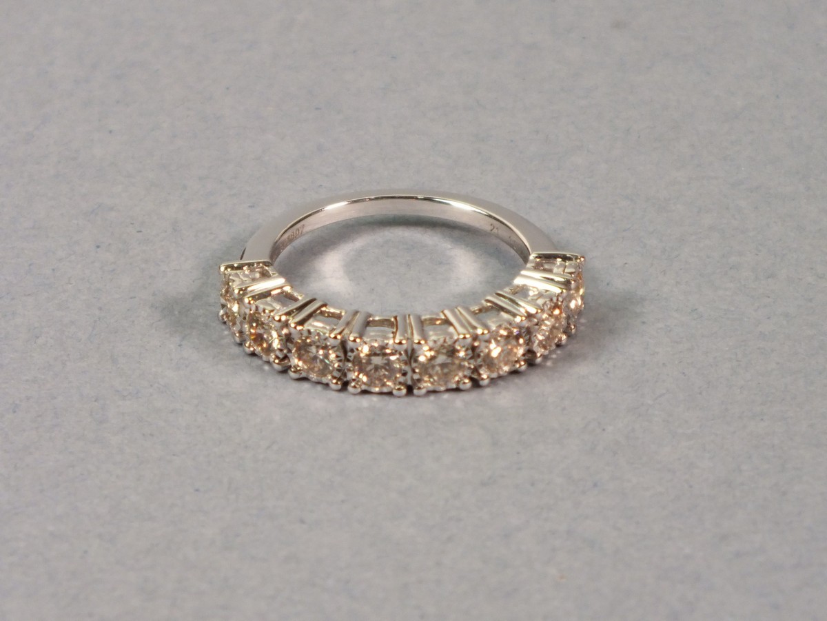 A 9ct white gold diamond set ring, with an arrangement of eight round brilliant cut diamonds, 3gms