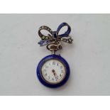 A ladies silver blue enamel lapel watch complete with paste and enamel silver bow slight cracking to