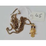 An attractive 14ct gold owl pendant 1.4g with enamel eyes on gilt metal chain