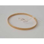 A 9ct engraved bangle - 7.3 gms