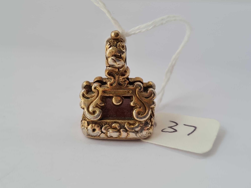 An ornate 19thc fob seal with stone intaglio to terminal