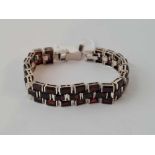 A silver and garnet set bracelet 43g inc