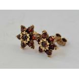 A pair of 9ct garnet flower earrings 3g inc