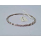 A VINTAGE SLAVE BANGLE SET WITH PINK SAPPHIRES 14CT GOLD