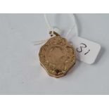 A fancy scroll engraved gold back & front locket