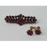 An antique garnet brooch (2 stones out) and garnet earrings