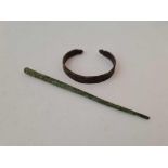 A Roman bronze stylus together with a Roman bronze bangle