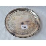 Victorian salver with flower engraved border and 3 bracket feet. 7 inch diam. London 1888 by G & J