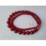 A LARGE CHERRY AMBER BEAD NECKLACE - 96 GMS