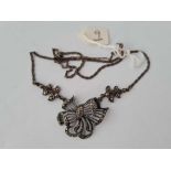 A silver and marcasite tied ribbon pendant on neck chain