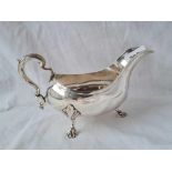 A good George III sauce boat with leaf capped double scroll handle, 7" wide, London 1768 by IM?,