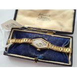 A ladies vintage hexagonal wrist watch 9ct on a rolled gold bracelet in a JW Benson Ltd box