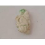 A Oriental carved jade pendant of a figure with monkey on shoulders
