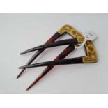 A pair of antique tortoise shell and decorative gilt mounted hair slides