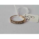 A diamond half hoop ring set in gold size N