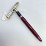 A maroon and silver coloured Sheaffer fountain pen with 14ct gold nib