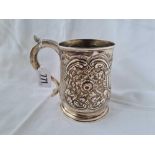 A good 18th Century Newcastle mug, embossed with scrolls and flowers, 5" high, marked on base and