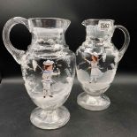 A pair of Marry Gregory glass jugs with loop handles - 9" high