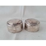 Two circular French jars and covers