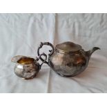 Ciecular French teapot and a cream jug