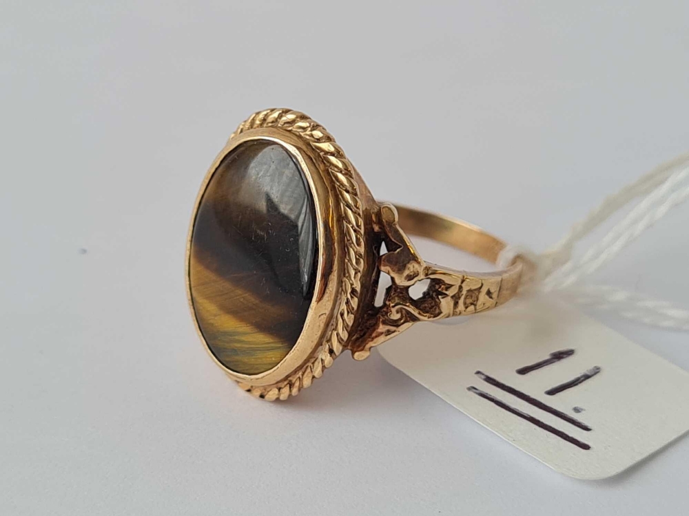 A oval tigers eye ring with 9ct chased and pierced mount size N - 4.4 gms - Image 2 of 3