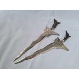 A pair of Eastern silver mounted daggers with wooden handles, 7" long, 90g