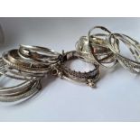 a bag of numerous silver bangles 8 oz.