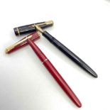 A maroon Parker fountain pen together with a black Parker fountain pen with 14ct gold nib