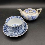 An English small blue and white teapot and a tea bowl and saucer