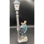 A large Lladro figure standing under a lamp post 12" high