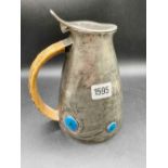 A Liberty & Co jug decorated with four enamel panels - 8" high