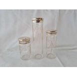 Three silver topped jars. London 1912 with etched glass bodies