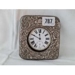 Gun metal cased travelling clock with silver mounted case